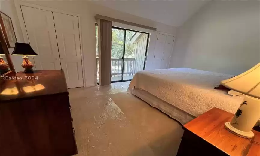 Bathroom with dual sinks, tile floors, a shower with door, and large vanity