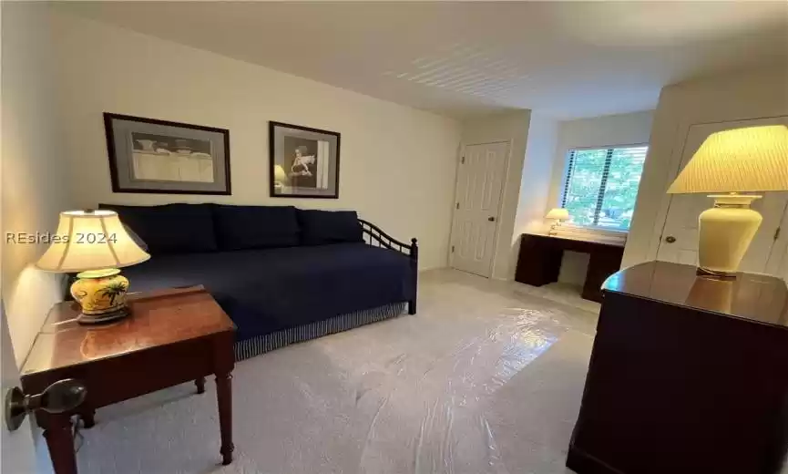 Bedroom with dark hardwood / wood-style floors, ceiling fan, and vaulted ceiling