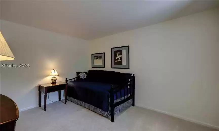 Bedroom featuring light colored carpet