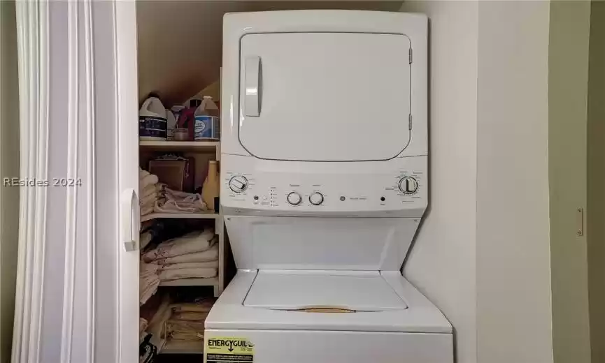 Washroom featuring stacked washing maching and dryer