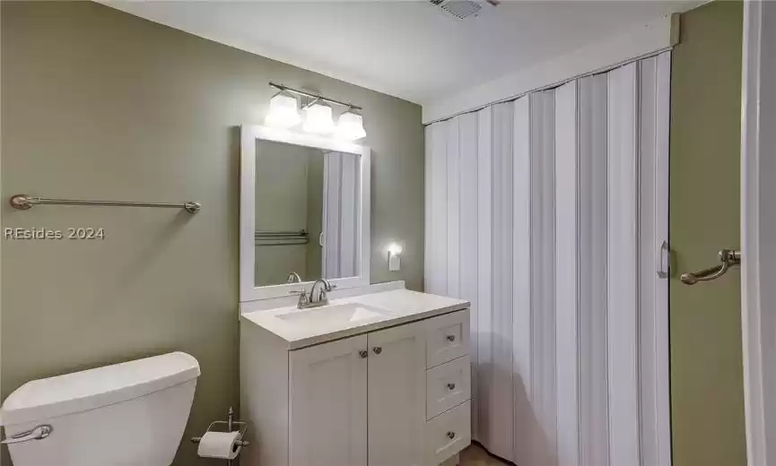 Bathroom featuring toilet and large vanity