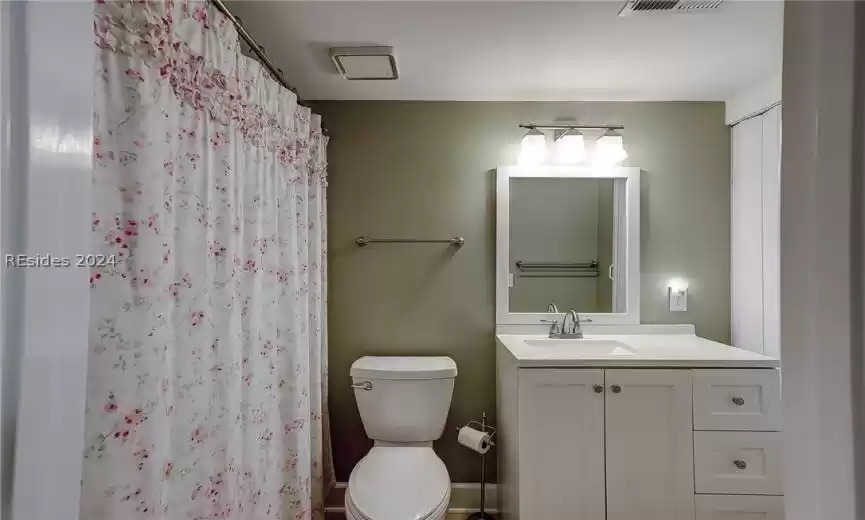 Bathroom featuring toilet and large vanity