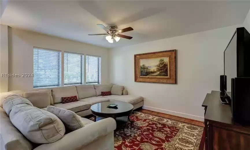 Living room featuring light hardwood / wood-style floors and ceiling fan