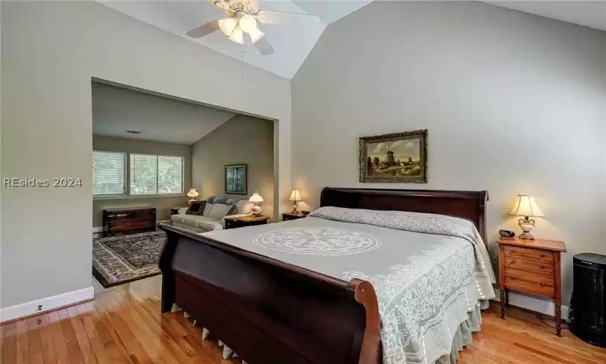 Bedroom featuring lofted ceiling, ceiling fan, and light hardwood / wood-style floors