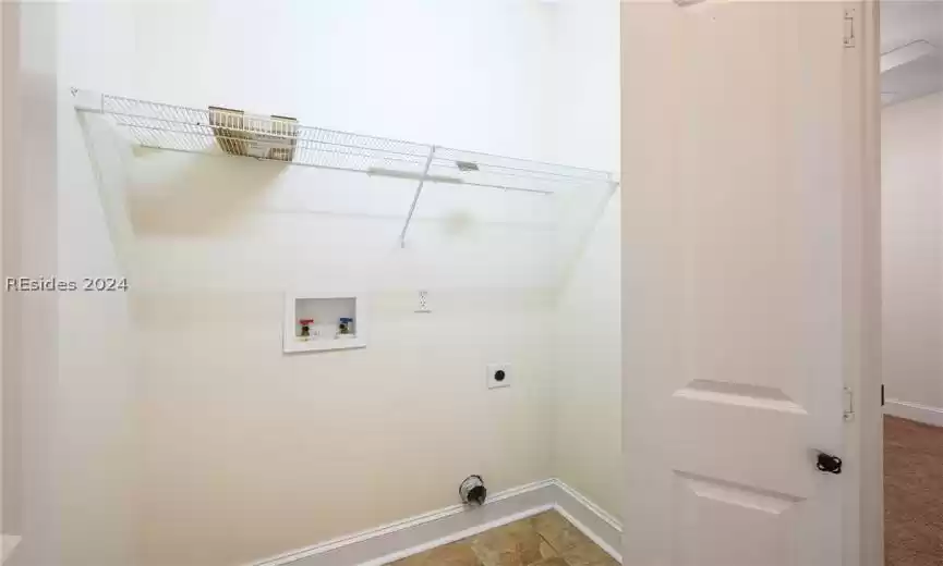 Laundry area with electric dryer hookup, light tile floors, and hookup for a washing machine