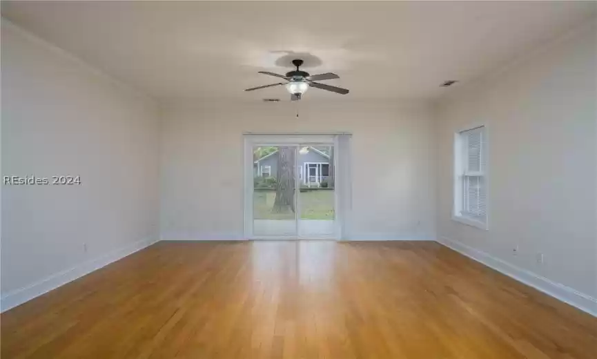 Unfurnished room with ceiling fan, light hardwood / wood-style flooring, and ornamental molding