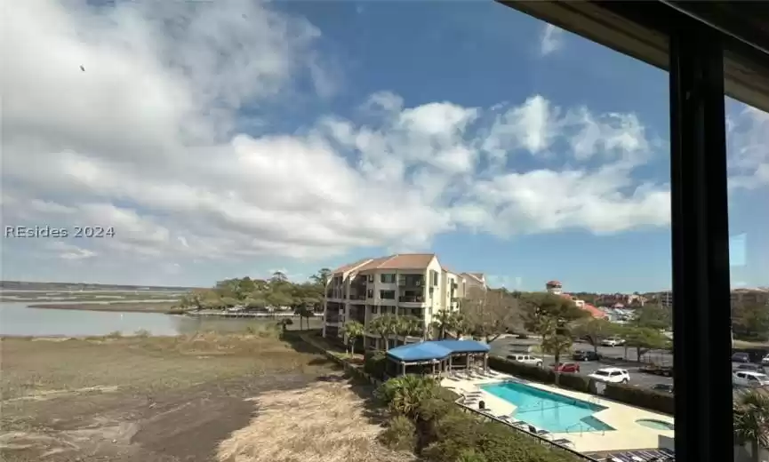 View of Shelter Cove Marina, Captain's Quarters Starboard building, and community pool.