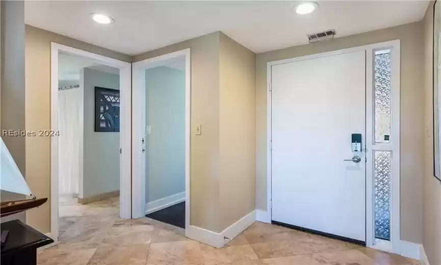 2009 Travertine flooring in entryway, with coastal decor.