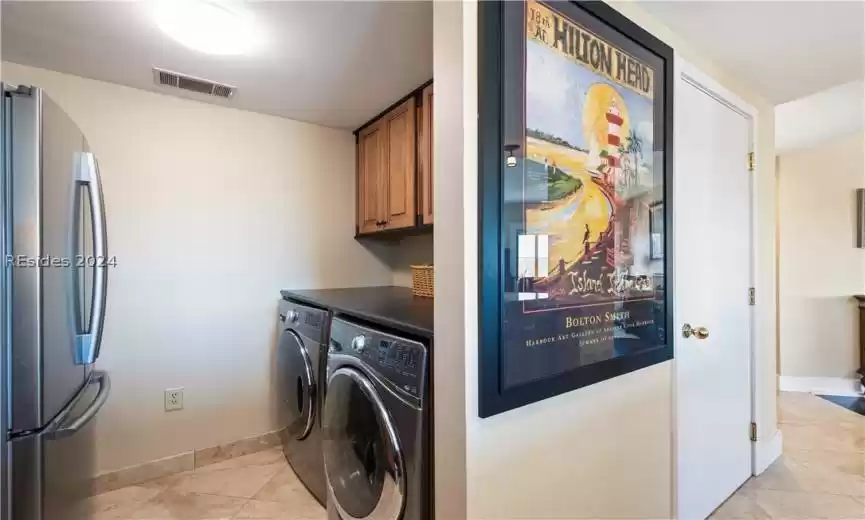 New washer and dryer conveniently tucked off of kitchen area.