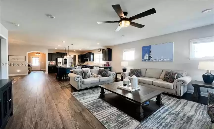 Kitchen featuring a kitchen bar, appliances with stainless steel finishes, light hardwood / wood-style flooring, a kitchen island, and hanging light fixtures