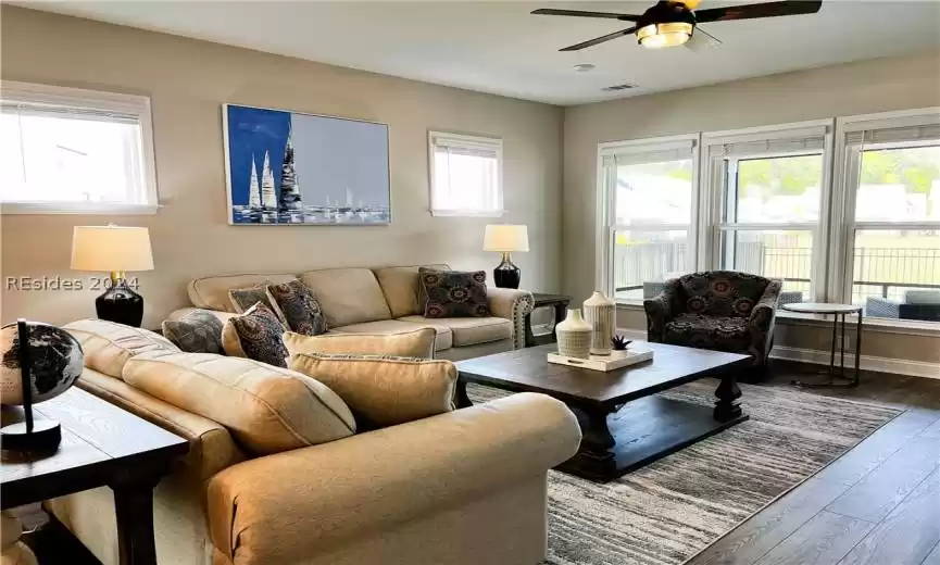 Rear view of house with a patio area, ceiling fan, and a lawn