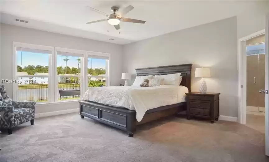 Bedroom featuring light carpet and ceiling fan