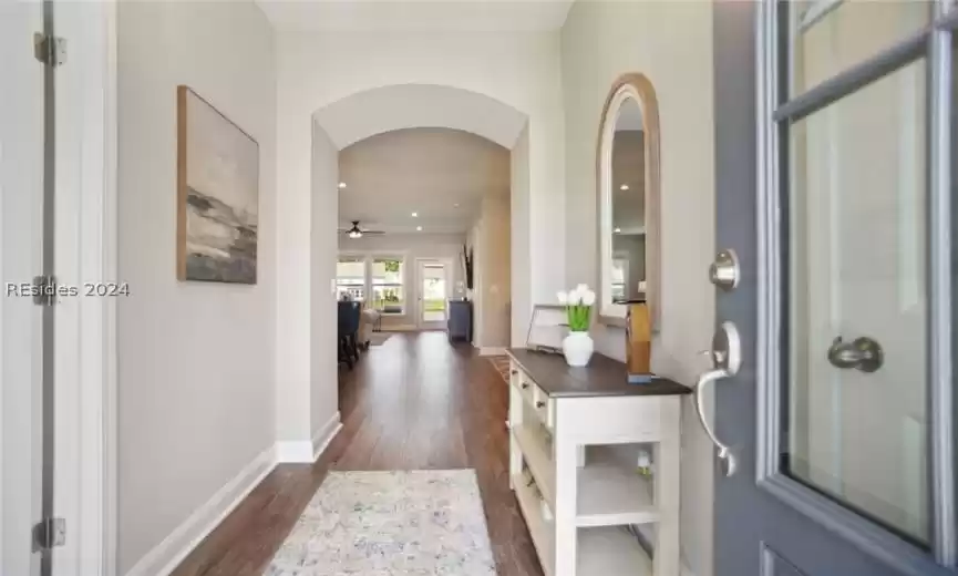 Foyer featuring dark wood-type flooring and ceiling fan