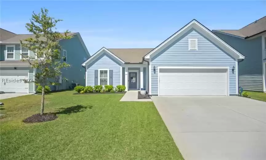 Ranch-style house with a front yard and a garage