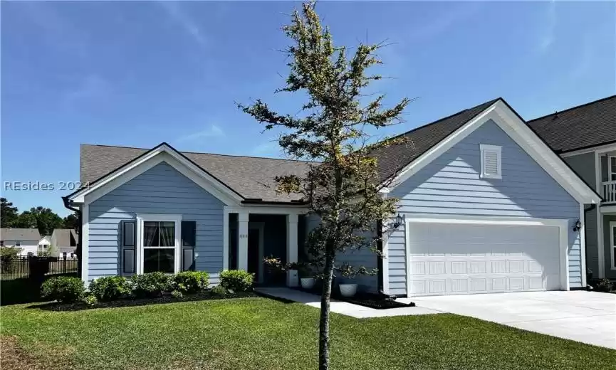 Single story home featuring a front lawn and a garage