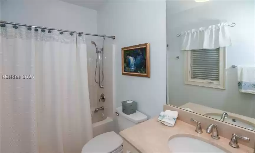 Full bathroom with shower/bath combo, comfort-height vanity and toilet