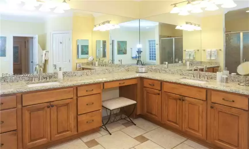 Bathroom featuring tile flooring, ornamental molding, and double-sink vanity