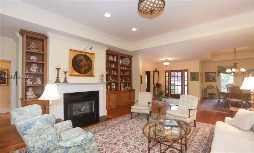 Living room featuring an inviting chandelier, crown molding, and 5