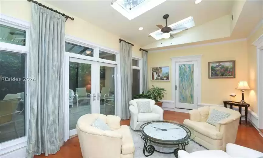 Beautiful Carolina Room with vaulted ceiling, skylights, ceiling fans door to the Primary Suite bedroom (handpainted).