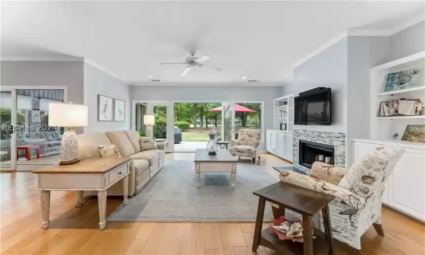 Open and updated living room with golf course views beyond the patio make this a warm, welcoming home