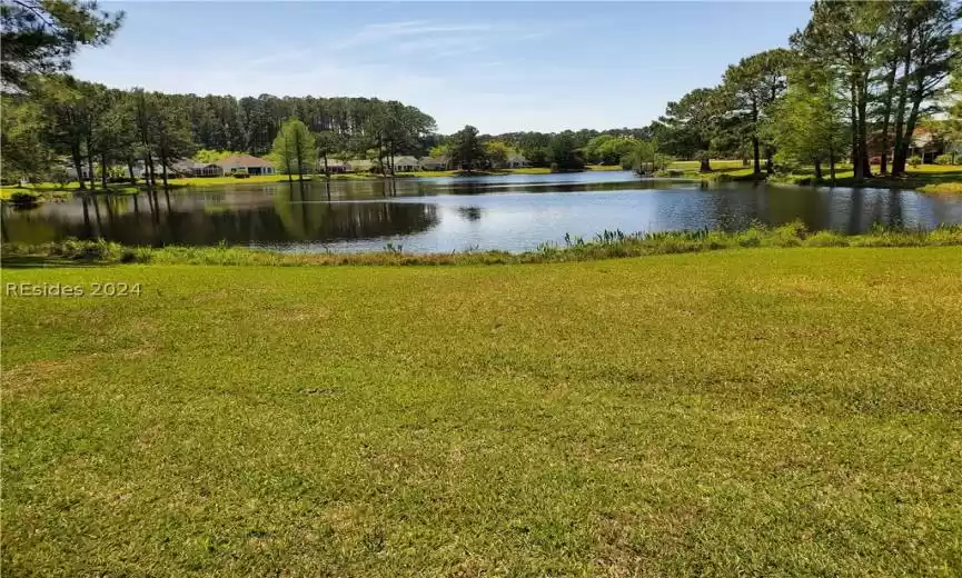 Look at the gorgeous lake behind this beautiful home!