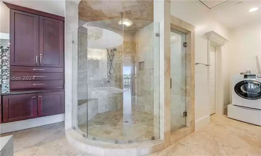 Curved spa-like shower and view into yet another laundry room on the 4th floor.