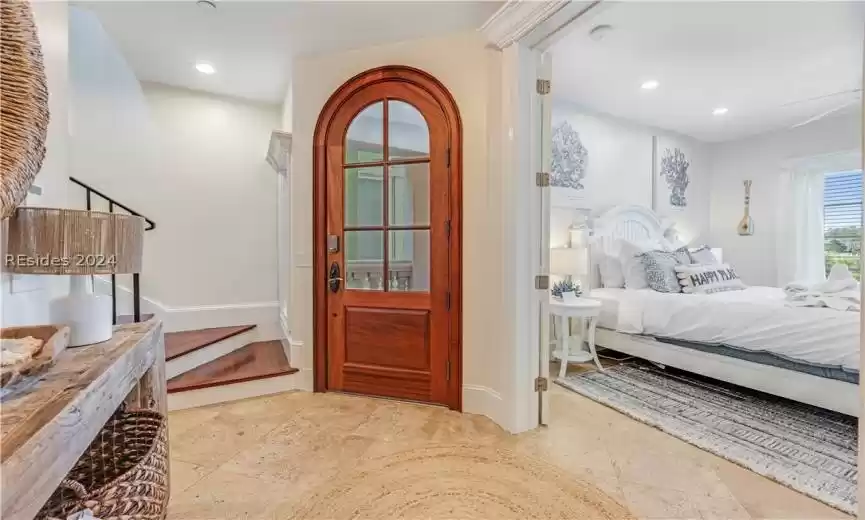 Front entrance into foyer on 2nd floor. French doors into 1st bedroom. Glimpse of stairway to 3rd floor living areas.