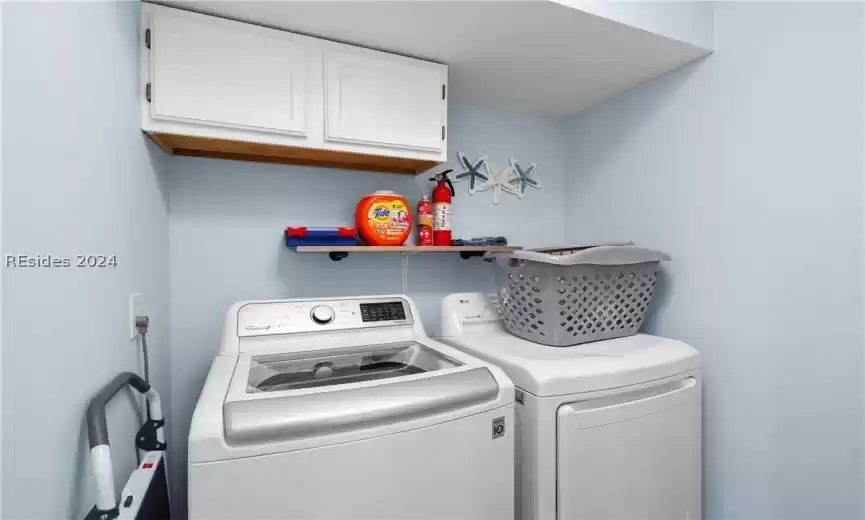 Laundry room next to kitchen area.