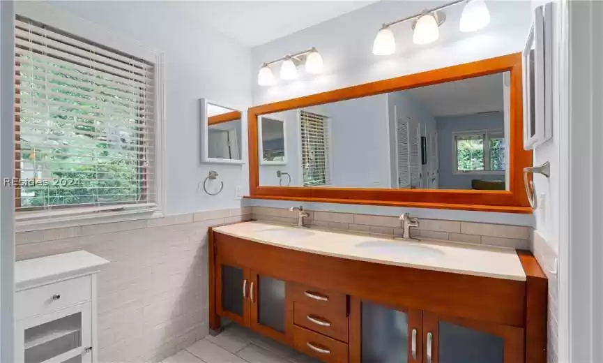 Primary Bathroom Vanity with double sinks and large wall mirror.