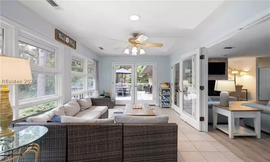 This Carolina Room is tiled and has French doors leading out to back wooden deck.