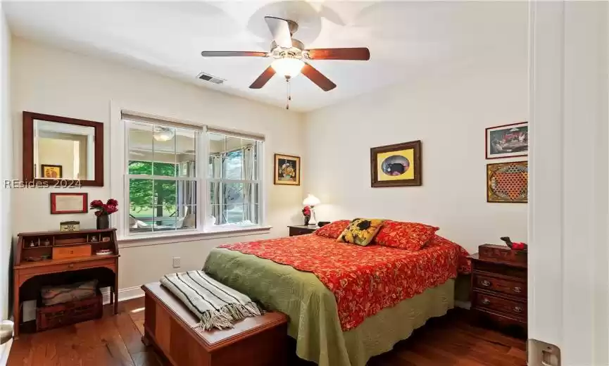 Bedroom featuring ceiling fan and hardwood flooring