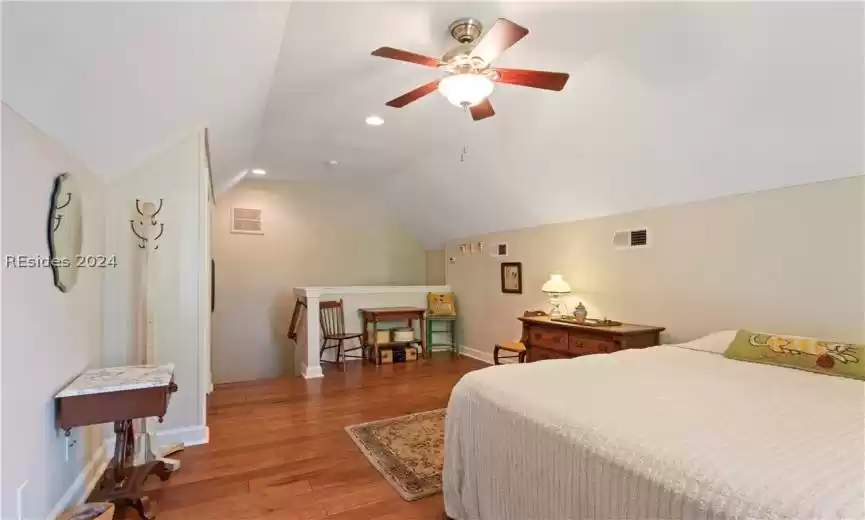 Upstairs Bonus Bedroom #4 with lofted ceiling, ceiling fan, and hardwood flooring