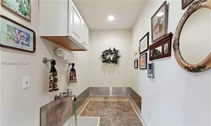 Mudroom featuring tile floors and wash sink