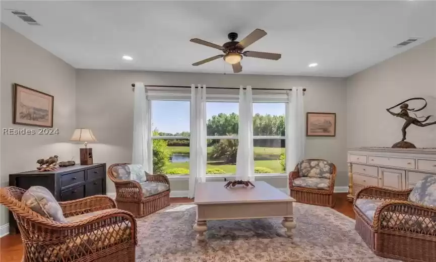 Living room featuring hardwood / wood-style floors and ceiling fan