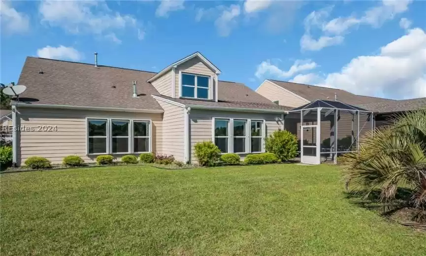 Rear view of house with a lawn