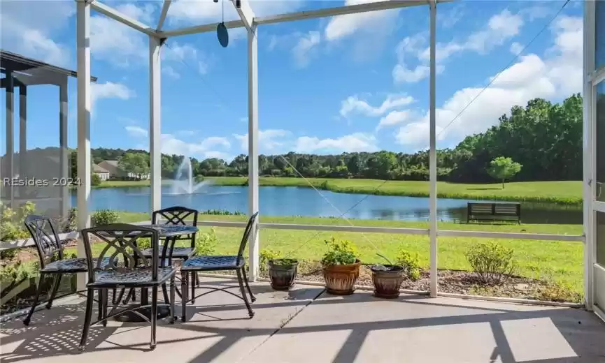 Sunroom featuring a water view