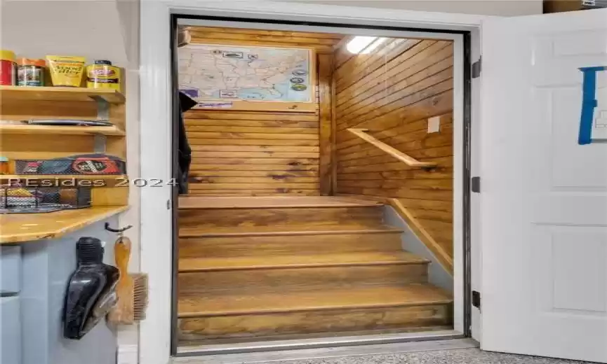 Staircase featuring wooden walls