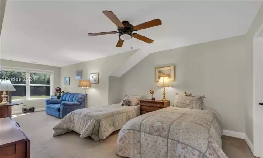 Bedroom featuring light colored carpet and ceiling fan