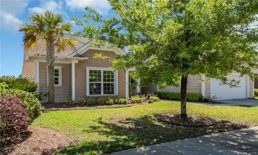 View of front of home featuring a garage and a front lawn