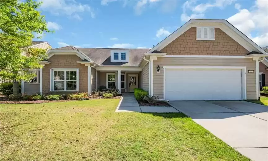 View of front facade with a front lawn and a garage