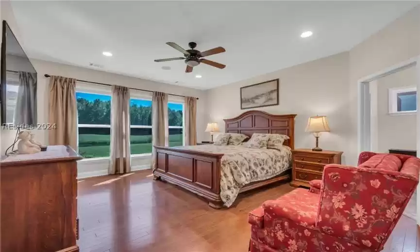 Bedroom featuring hardwood / wood-style floors and ceiling fan