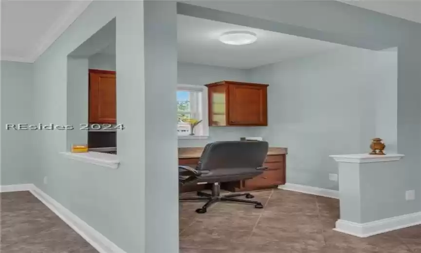 Office area featuring crown molding and tile floors