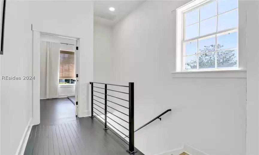 Primary Bedroom with ornamental molding, ceiling fan, light wood-type flooring, and multiple windows