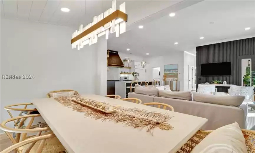 Hallway with plenty of natural light and dark hardwood / wood-style floors