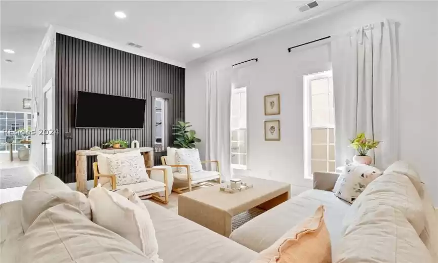 Main Living room featuring crown molding and light wood-type flooring