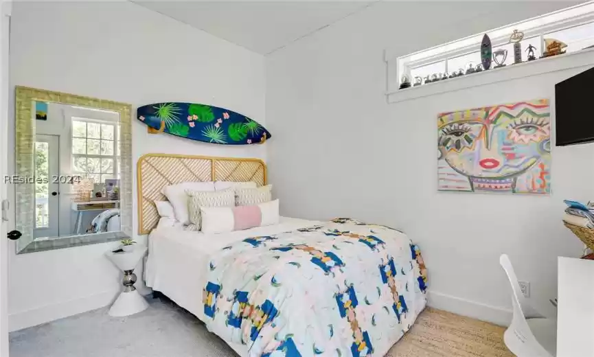 Guest Bedroom  1 featuring a closet and light colored carpet