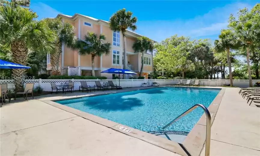 Entrance to property with a balcony and ceiling fan