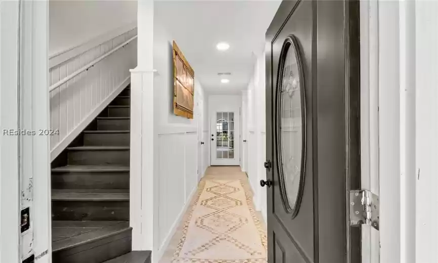 Guest Bedroom 3/Flex space with light hardwood / wood-style flooring and ornate columns