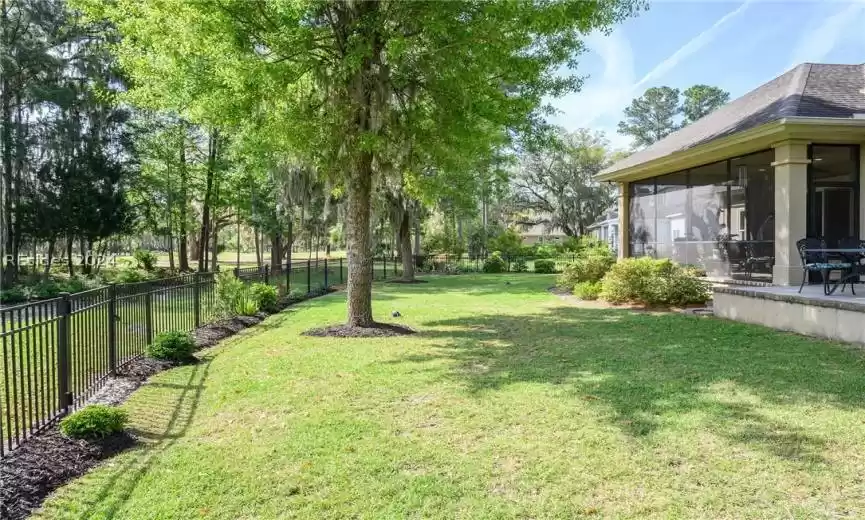 Fenced yard with view of golf and water views of the marsh.