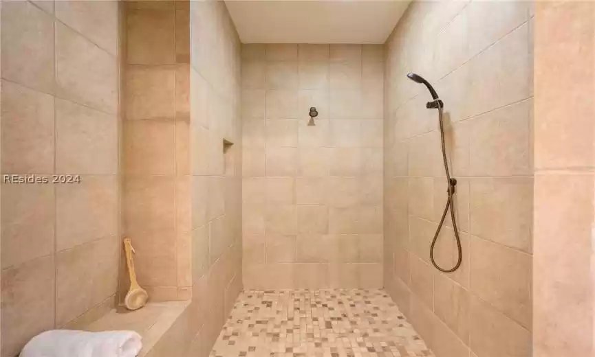 You'll never get tired of showering in this walk-in shower! Main shower head and hand-held plus a generous  sitting area.